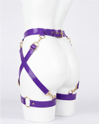 A glossy purple latex waist and leg harness set by Ribcage, featuring structural straps, metallic O-rings, and adjustable buckles.