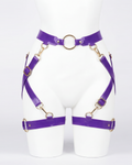 A glossy purple latex waist and leg harness set by Ribcage, featuring structural straps, metallic O-rings, and adjustable buckles.