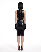 A model shown from the back wearing the high-shine black latex The Arbiter Dress by Ribcage Latex, featuring contoured seaming, a half-length back zipper, and a knee-length compressive cut.
