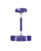 A back view of the metallic purple latex harness set by Ribcage, highlighting the buckle closure on the choker and the double-row snap button closure on the waist belt, accented with silver hardware, displayed on a clean white background.