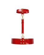 A back view of the red latex harness set by Ribcage, highlighting the buckle closure on the choker and the double-row snap button closure on the waist belt, accented with gold hardware, displayed on a clean white background.