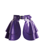 A high-shine metallic purple latex peplum overlay belt by Ribcage, featuring a structured waist belt with a silver metallic buckle, hardware rings, and a double-layer flounce peplum.