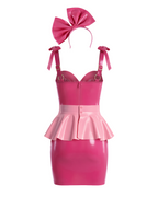A back view of the high-shine color-blocked latex three-piece suit by Ribcage, highlighting the vivid fuchsia slip dress with a back zipper closure, the metallic pink peplum overlay, and the vivid fuchsia bow headband, displayed on a clean white background.