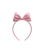 A high-shine metallic pink latex headband by Ribcage, featuring a sleek band crowned with a dramatic, oversized structural bow at the top.