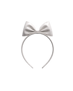 A high-shine white latex headband by Ribcage, featuring a sleek band crowned with a dramatic, oversized structural bow at the top.