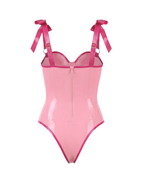 A metallic pink latex bodysuit by Ribcage, featuring a sweetheart neckline with a center bow, structured bow shoulder straps, and a high-cut leg silhouette.