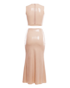 A high-shine nude latex two-piece ensemble by Ribcage, featuring a minimalist sleeveless crop top and a high-waisted maxi skirt with a dramatic side slit and a polished metal buckle accent, designed with a compressive second-skin fit.