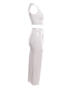 A  high-shine white latex two-piece ensemble by Ribcage, featuring a minimalist sleeveless crop top and a high-waisted maxi skirt with a dramatic side slit and a polished metal buckle accent, designed with a compressive second-skin fit.
