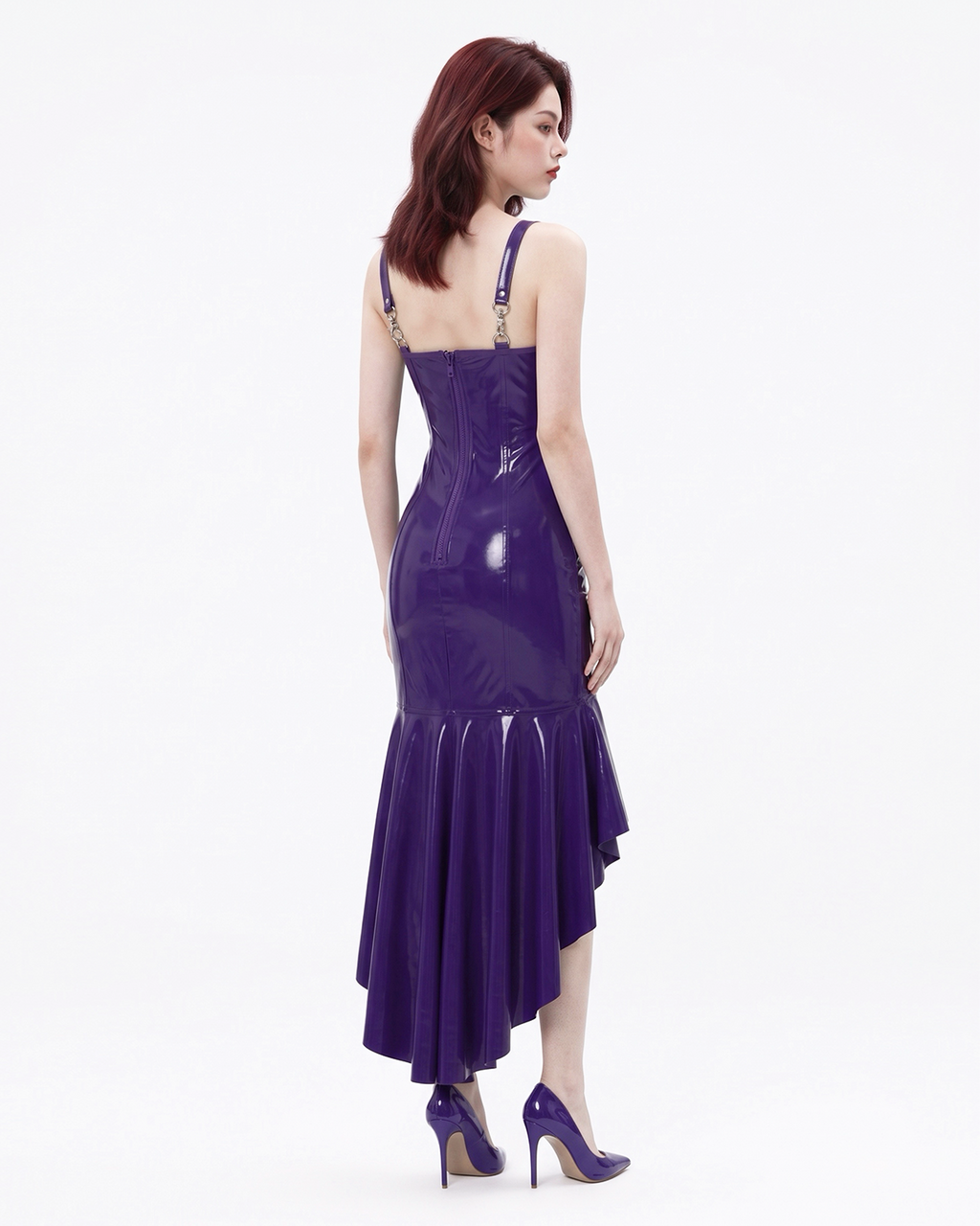 A model shown from the back wearing a high-shine purple latex mermaid dress by Ribcage, highlighting the adjustable straps and cascading flounce hem.