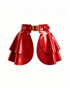 A glossy red latex peplum overlay belt by Ribcage, featuring a structured waist belt with a silver metallic buckle, hardware rings, and a double-layer flounce peplum.