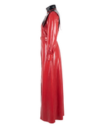 A glossy high-shine red and black latex four-piece trench suit by Ribcage, featuring a long-sleeve trench coat, a triangular capelet, a structured body harness, and an inner mock-neck dress.